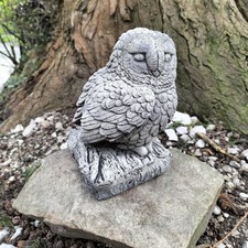 Stone garden barn owl on log