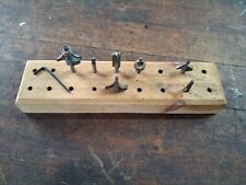 Assortment of 1/4" shank router bits and homemade wooded storage block