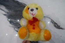 yellow/orange teddy bear with bow tie. Soft, plush and good to snuggle into.