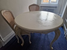 Cream round dinning table with two chairs