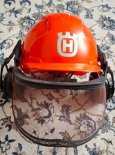 Husqvarna safety helmet with fitted mesh screen and ear defenders.