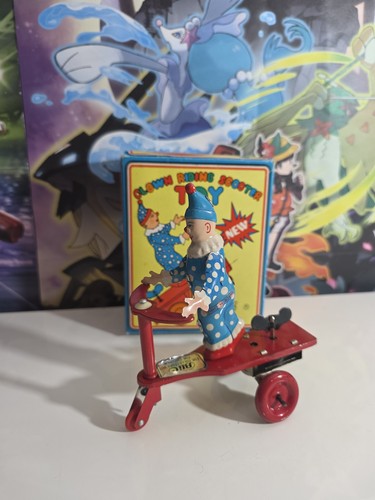 Tin wind toy clown on - tin,