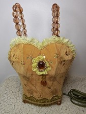 Table lamp corset-shaped with gold toned velvet finish, lace and beaded handles