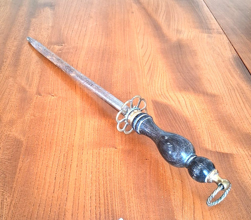 Antique fire poker with wooden