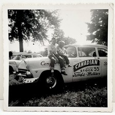 1950s Two Boys Sit on Canadian