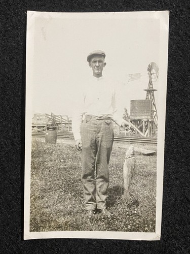 Man holding fish near - fish, windmill