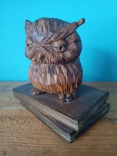 Wooden carving of grumpy owl