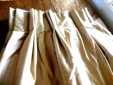 Pair of pale gold slub silk curtains, interlined, blackout lining, heavy