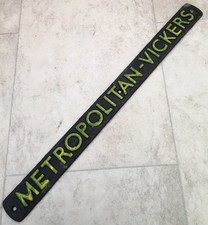 A VINTAGE CAST IRON NAME PLATE