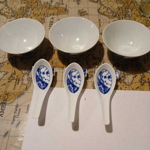 3chinese bowls with - with, spoons