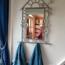 ornate seashell design mirror with towel hooks