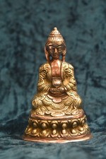 Miniature but heavy  Buddha figurine very detailed made in brass and copper.
