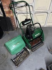 Qualcast Classic F35S Petrol Self Propelled mower and scarifier attachment.