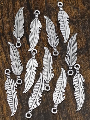 Silver tone feather charms - 12,