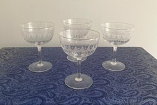 A superb set of 4 old vintage Etched Champagne Glasses