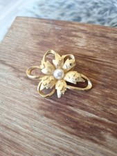 Vintage 1950s Sphinx gold-tone and pearl textured brooch.