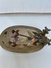 soap dish, likely made of brass or a metal, designed to hold a bar of soap