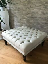 large buttoned footstool linen