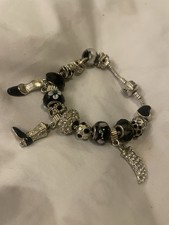 Pandora bracelet with 925 silver charms. In good used condition