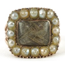 A Victorian unmarked rose gold seed pearl and hairwork mourning ring