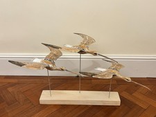 Archipelago wooden sculpture of three flying Eurasian Curlews