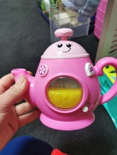 A toy, a musical kettle, tea