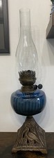 Antique Blue Ribbed Glass Oil Lamp With Cast Base And Bird Decoration.
