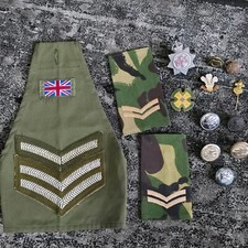 Uk military brassard with mixed buttons, broches and pins
