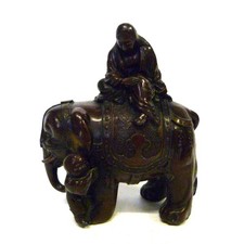 ANTIQUE BRONZED CHINESE FIGURE OF A MONK RIDING AN ELEPHANT