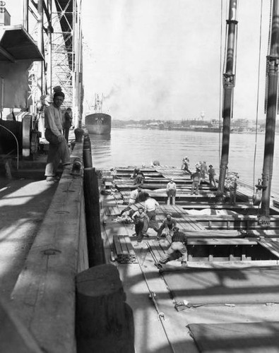 Workers unloading grain