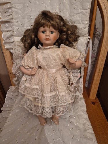 Seated porcelain doll - seated,