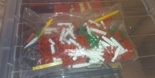 Sealed Bag Of Mostly Red & Green K'nex Pieces. Not Complete Kit