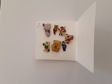 Pin Badges one is Wooly bear and one is a Telly tubby . 