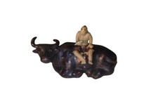 Man Sitting On Sitting Buffalo