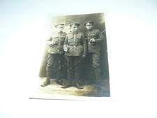 Real Photo Postcard - 3 soldiers of the Wiltshire Regiment - 1 smoking a pipe