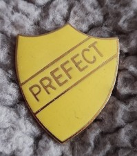 yellow enamel prefect badge