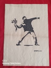 Banksy painting and drawing on