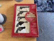 vintage crescent metal toy gun set in miniture , the 5 most famous guns used