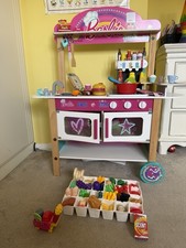 Barbie toy kitchen on wheels with lots of food and saucepans