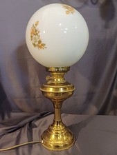 Lovely brass reproduction oil lamp. Vintage white globe shade with floral motif.