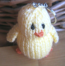 A HAND KNITTED FARMYARD CHICK
