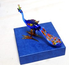 Glass peacock figurine beak to