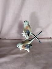 Porcelain long-tailed tit birds on a branch by Karl Ens