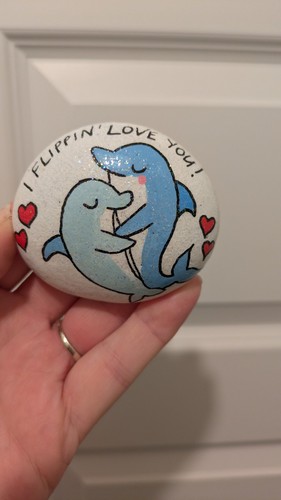 Hand painted pebble dolphins - hand,