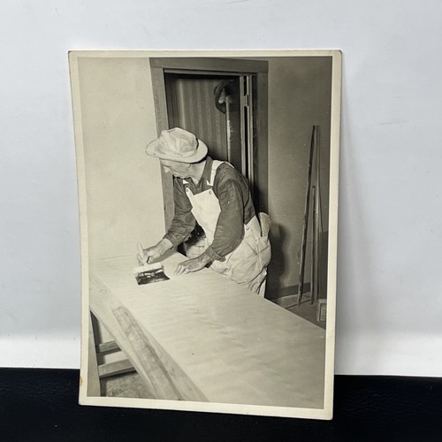 Man pasting wallpaper 1950s - man,