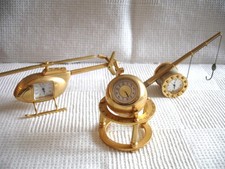 Three miniature themed working brass quartz clocks
