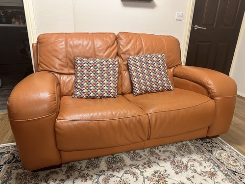 Orange leather seater - sofa,