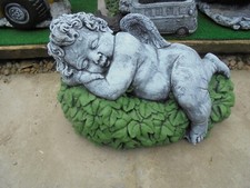 Cherub sleeping on a bed of leaves concrete garden ornament