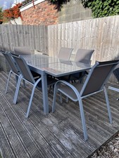 Grey Glass Top Metal Extending Garden Table with Six Mesh Back Chairs