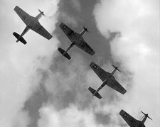 FOUR P-51 MUSTANGS FLYING IN